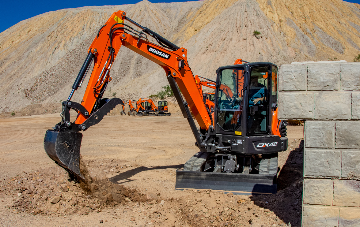 Photo of Doosan mini excavator digging at The ROC with other Doosan equipment in the background.