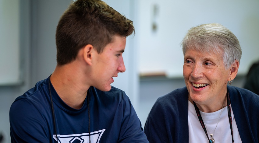 A grandchild and grandparent looking at each other during a Road Scholar program