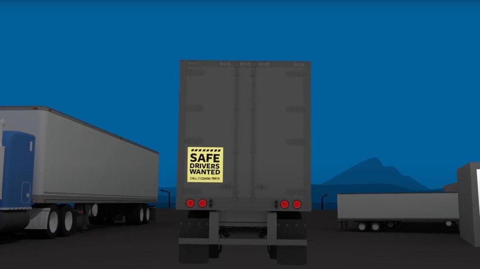 Back of truck showing yellow safe drivers wanted sign