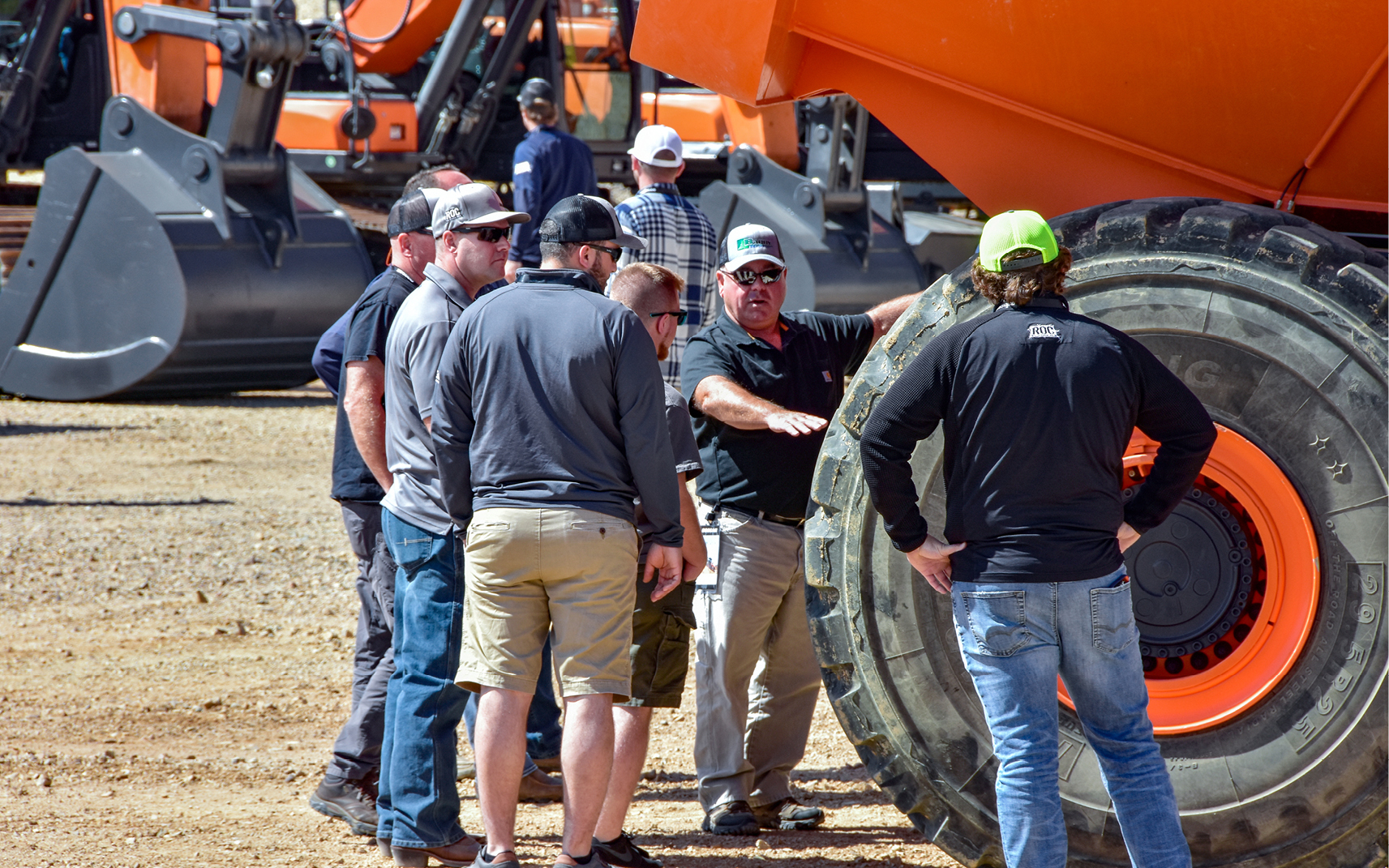 Photo of Doosan mini excavator digging at The ROC with other Doosan equipment in the background.