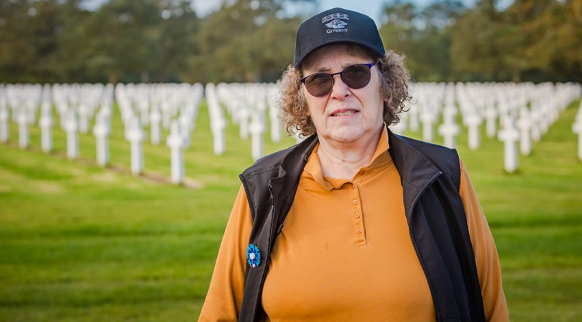 A veteran standing in front of the graves at the Normandy American Cemetery