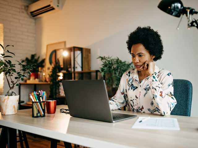 woman at desk on phone