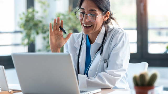 Doctor greeting participant on virtual meeting