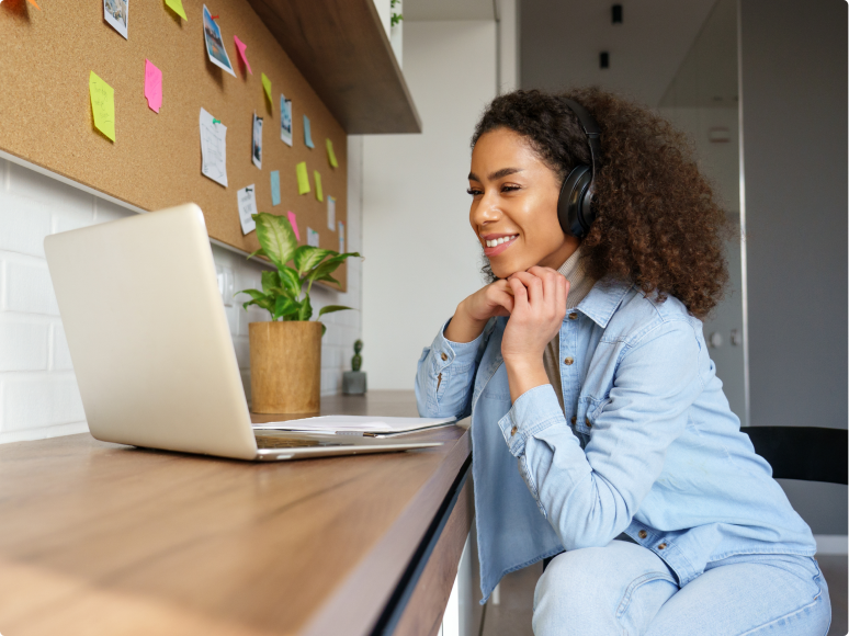 women smiling at laptop