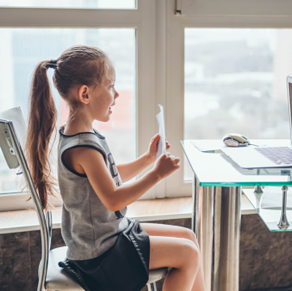 Child displaying paper to Virtual meeting Child displaying paper to Virtual meeting
